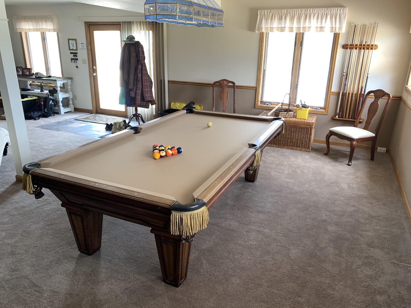 A freshly serviced pool table with new camel felt and leather fringe pockets in a bright Colorado home