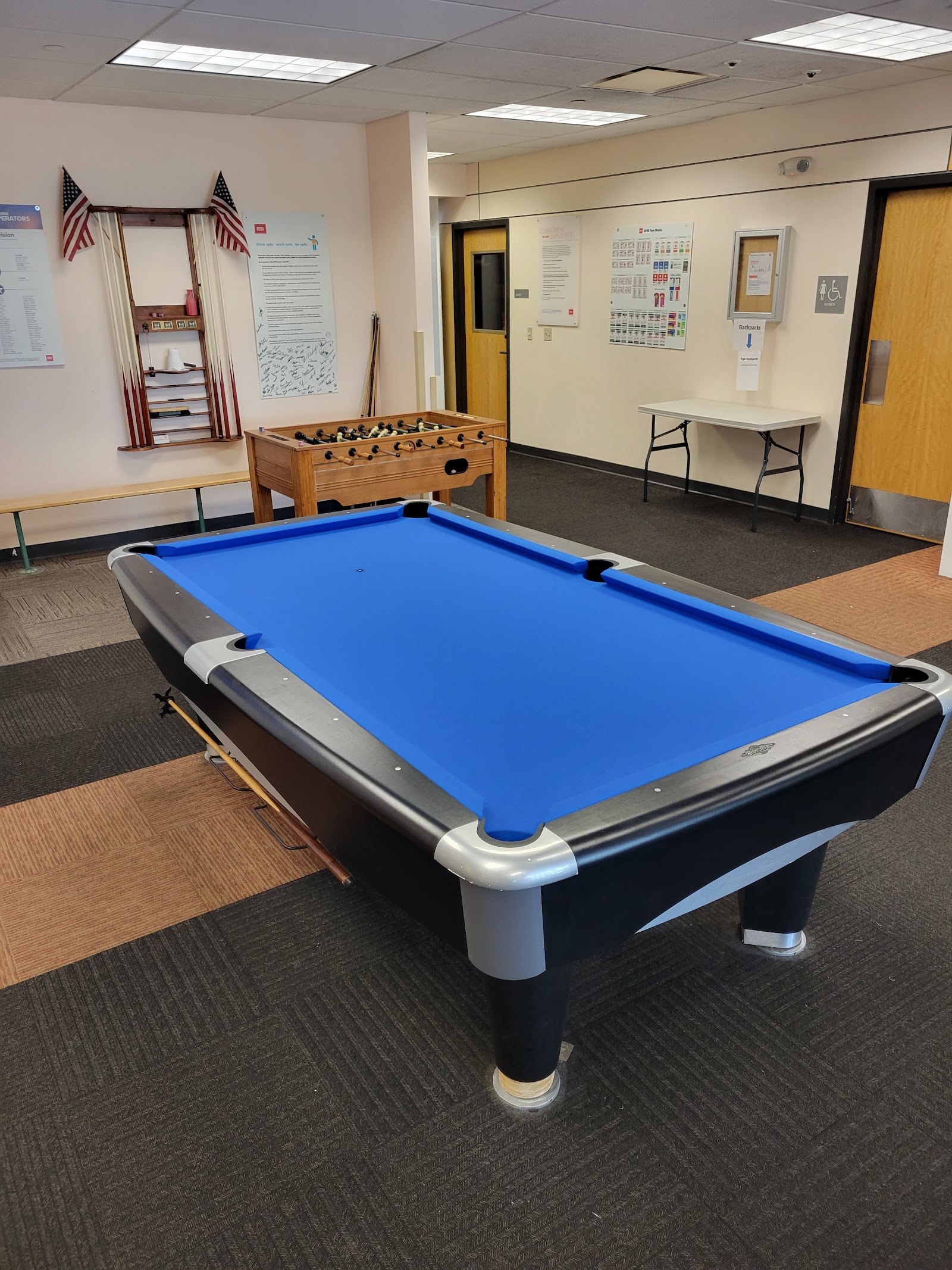 Commercial pool table with fresh tournament-blue cloth in a community room