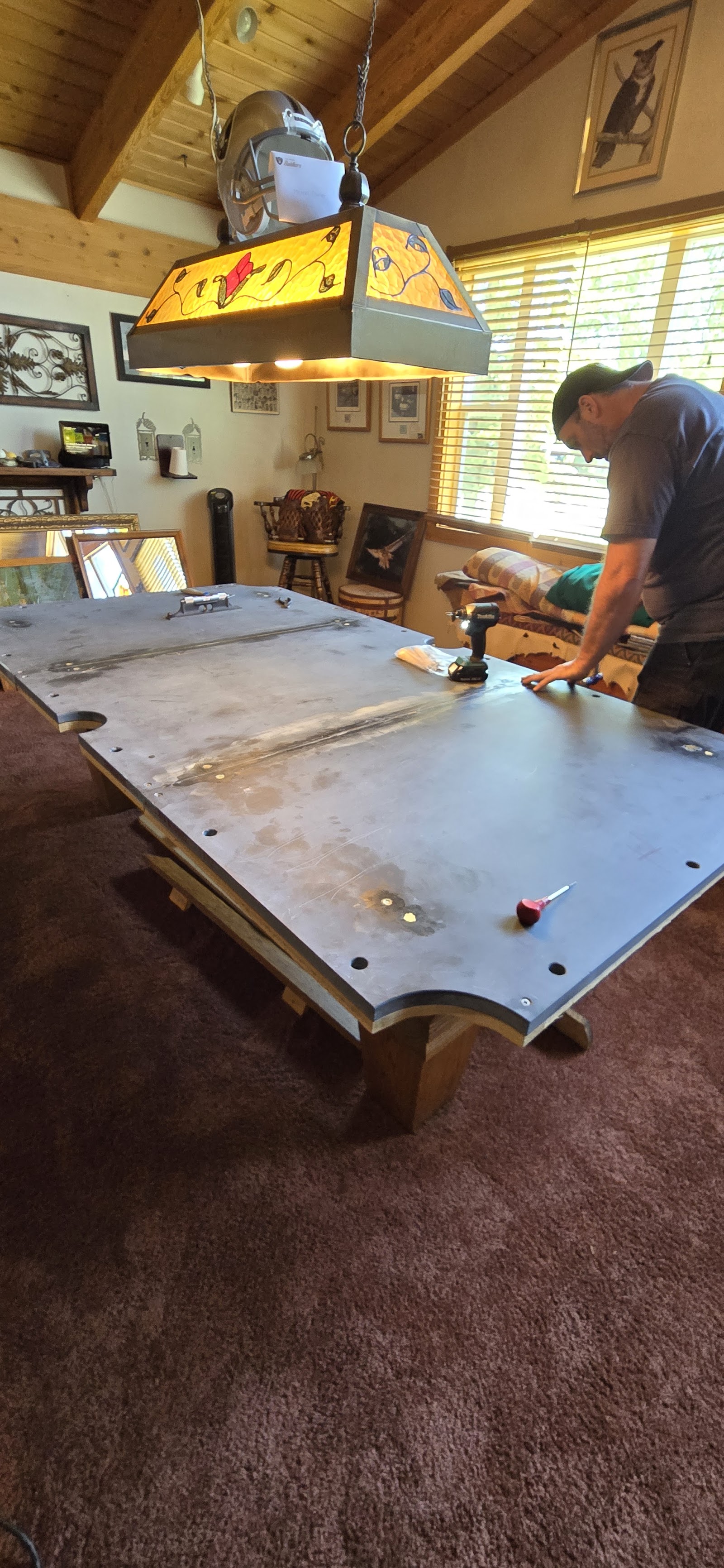 Ryan working on exposed slate during a pool table rebuild, cloth removed